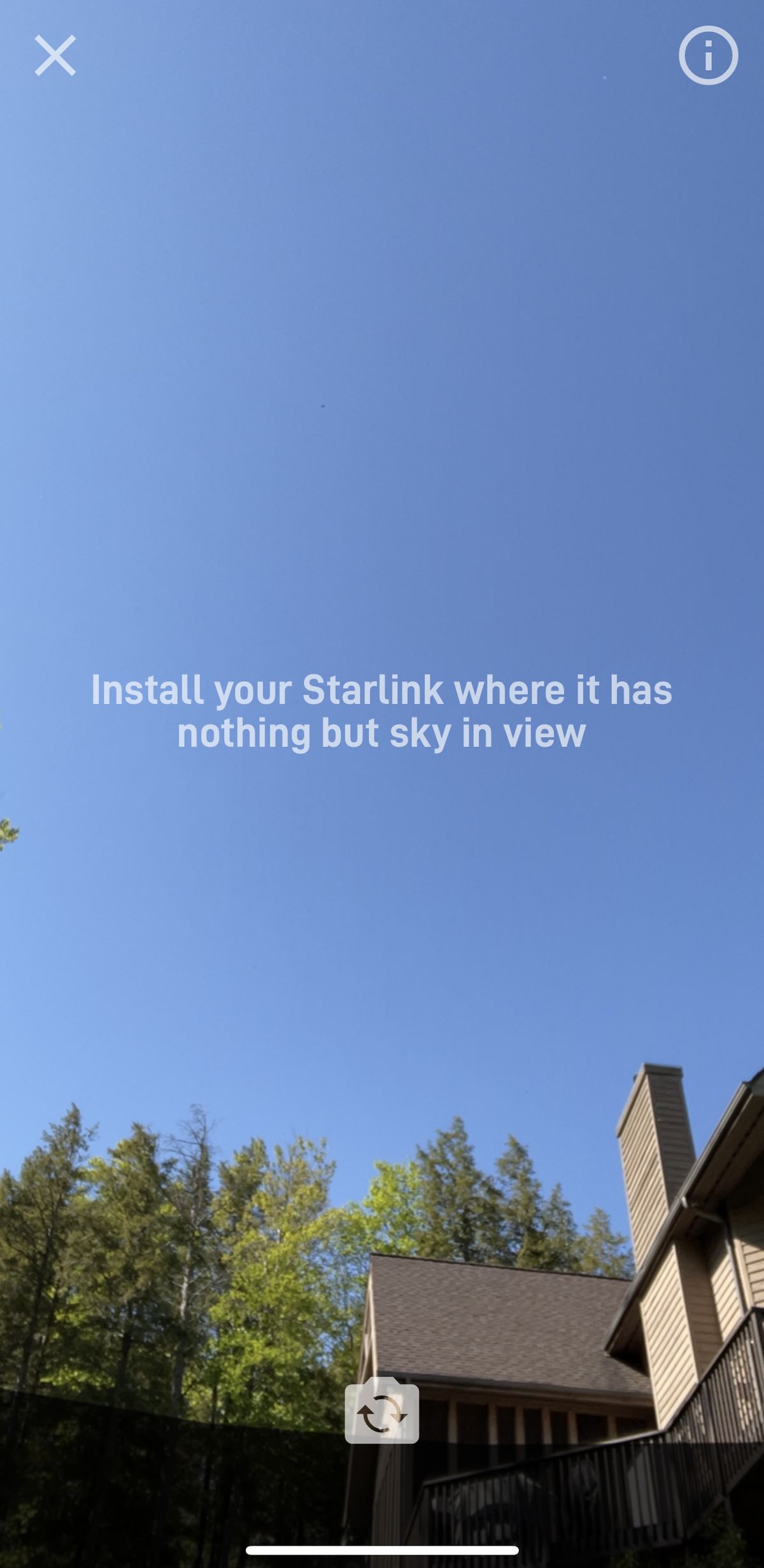 Starlink’s entire field of view is open sky except for the top of a house and the trees behind it, as seen from the app.