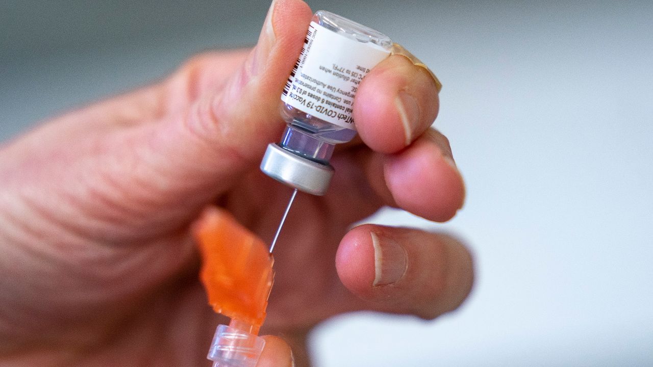 the syringe is loaded with Pfizer-BioNTech COVID-19 at a clinic in Richmond, British Columbia, Canada.  On Wednesday, May 5, 2021, the Canadian Health Authority granted the Pfizer vaccine to those 12 years of age and older.  (Through Jonathan Hayward / The Canadian Press AP)