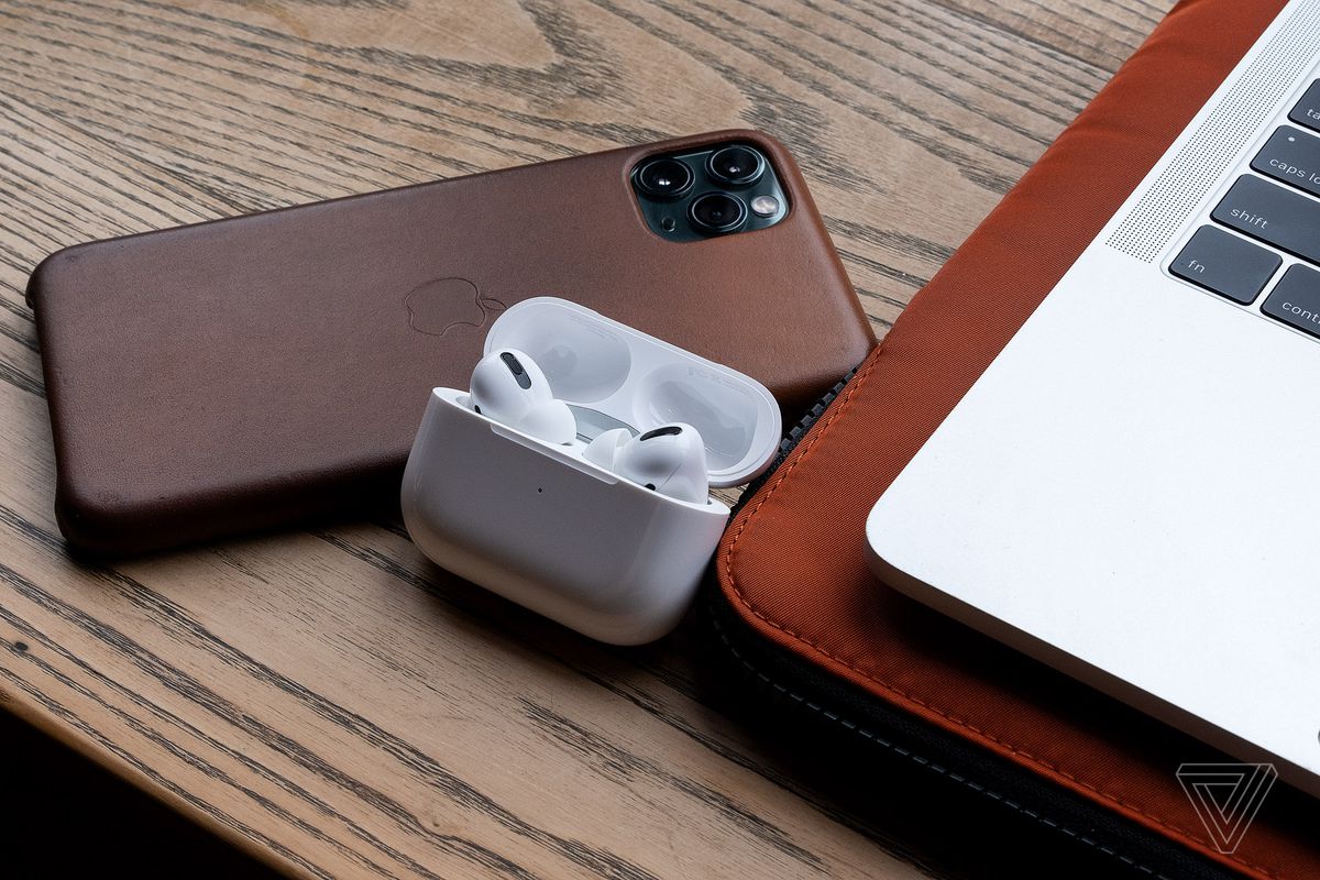 The AirPods Pro, the best wireless in-ear headset for people who use Apple products, is pictured next to the iPhone 11 Pro Max and MacBook Pro.