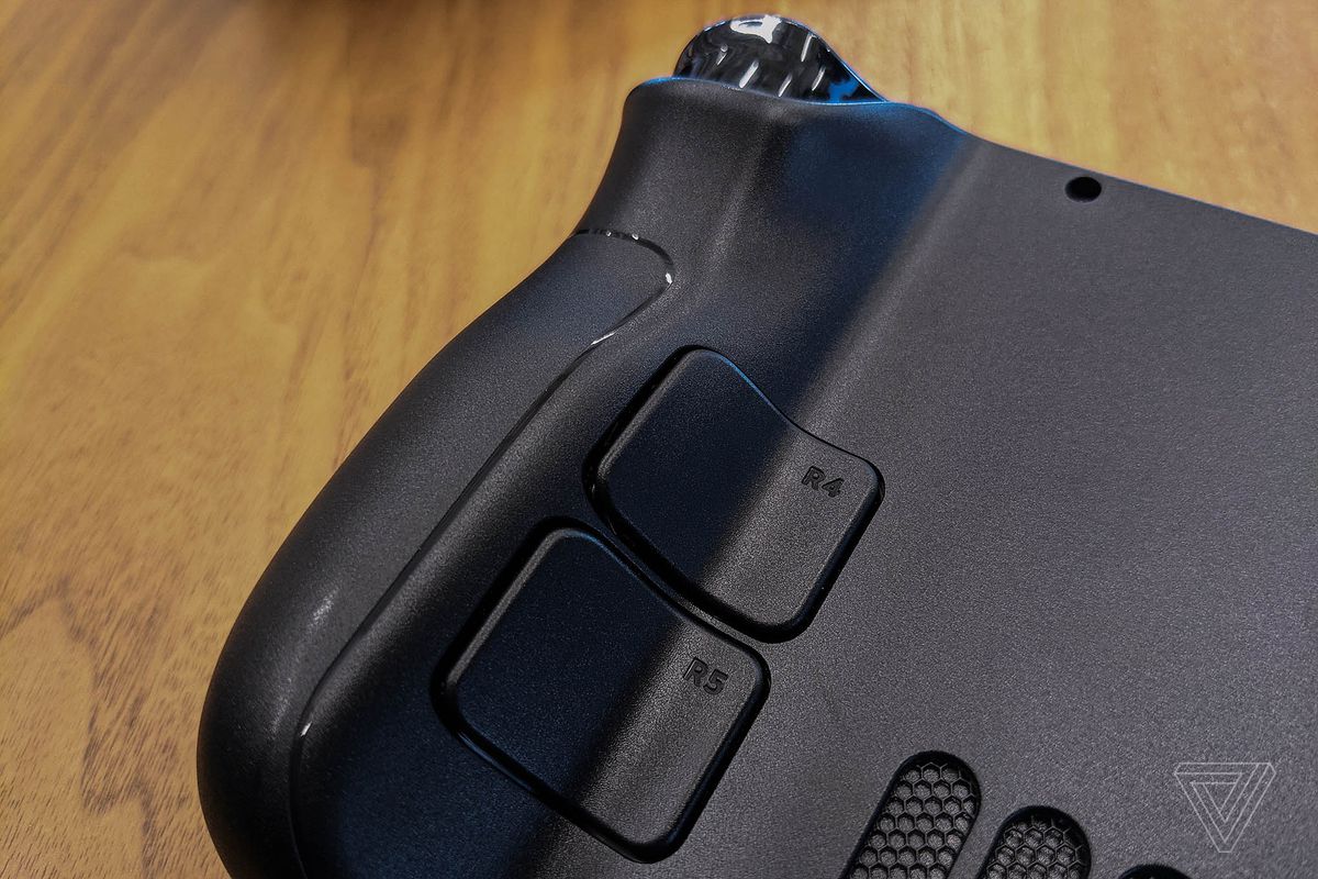 A close-up of a large grip on the steam lid that shows out and also shows its back buttons